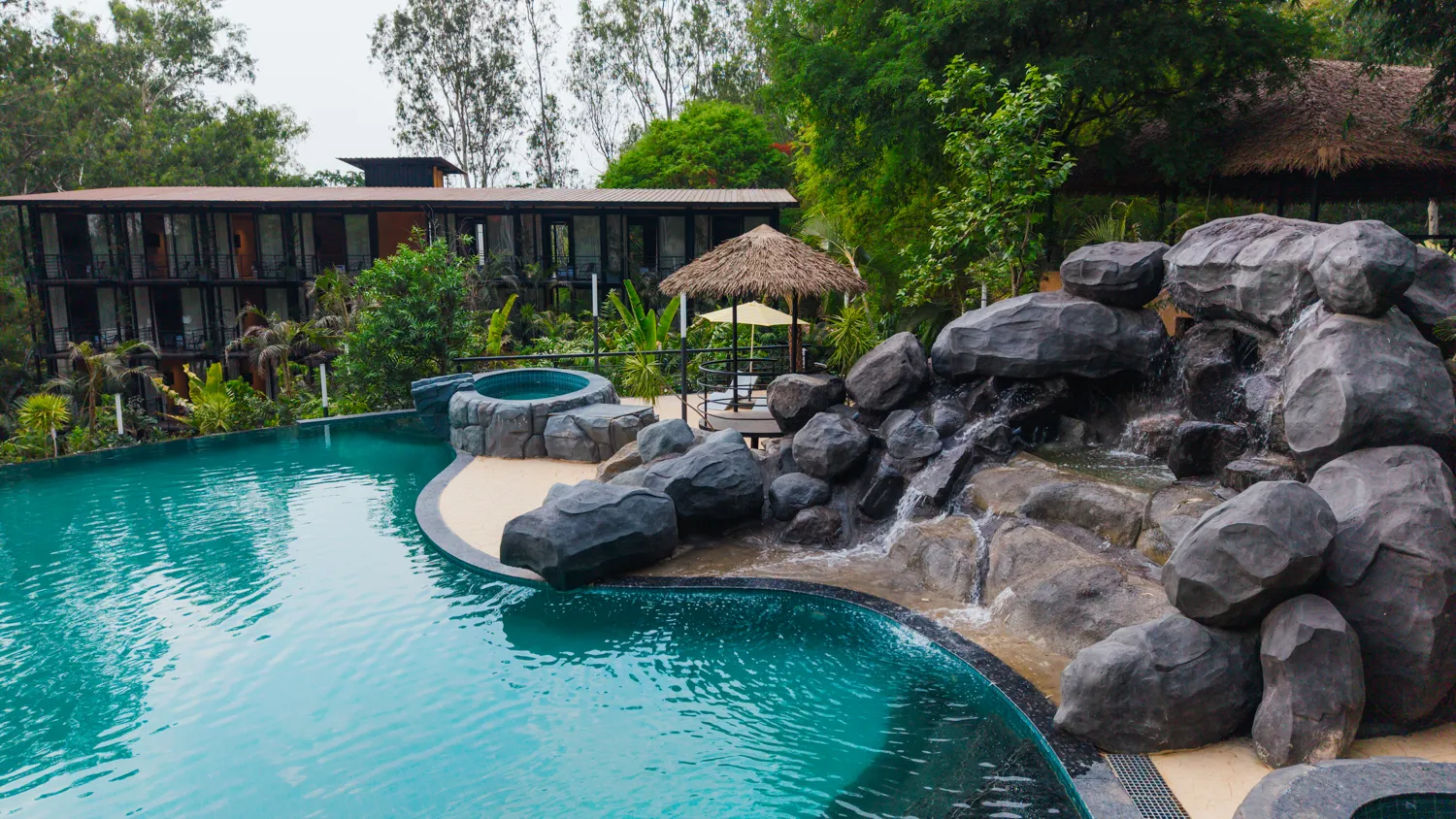 Natural lagoon pool with rocks and waterfalls at Area 83