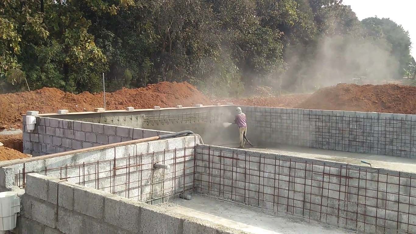 Shotcrete being sprayed over a steel reinforcement cage on site